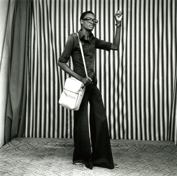 Young man with bellbottoms, satchel, and watch. 1977 ©Malick Sidibé, Courtesy of André Magnin, Paris